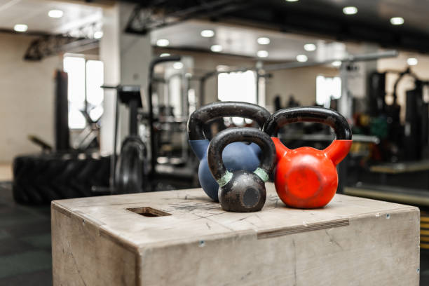 istock Functional training equipment. Kettlebells on a wooden box in modern gym 1297636101
