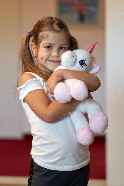 istock Little girl holding her toy 1297637517