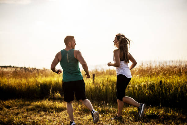 istock Two young athletes running in nature on sunny day 1297638510