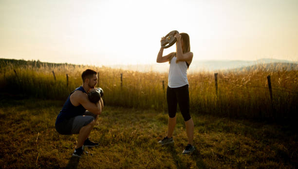 istock Two athletes exercising with kettlebell in nature 1297638638