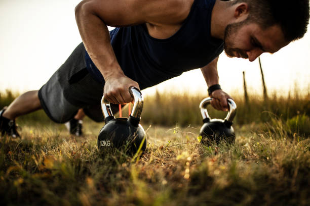 istock Male athlete exercising in nature and doing push ups 1297638693