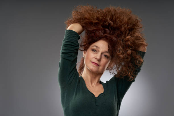 istock Senior woman on gray background 1297639730
