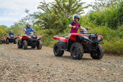 Group of tourists driving quad bikes Costa Rica