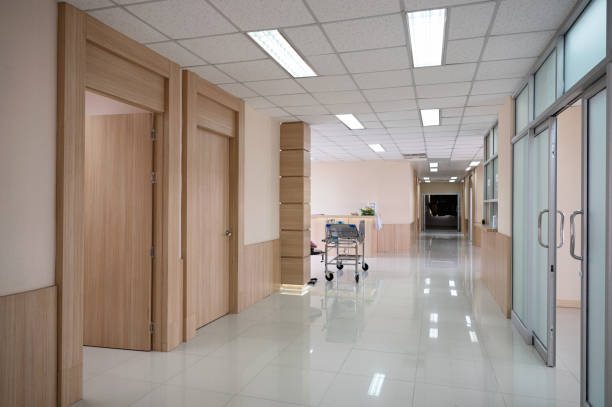 istock Empty hospital corridor with various rooms and trolley patient service 1297641571