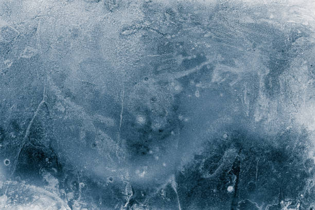 istock Ice texture background. Textured cold frosty surface of ice block on dark background. 1297643286