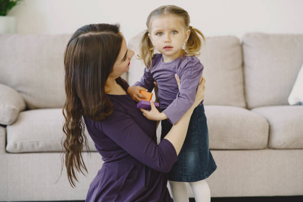 istock Cheerful mom playing laughing with little kid daughter 1297644149