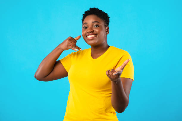 istock Plus-Size African Woman Gesturing Call Me Over Blue Background 1297644940