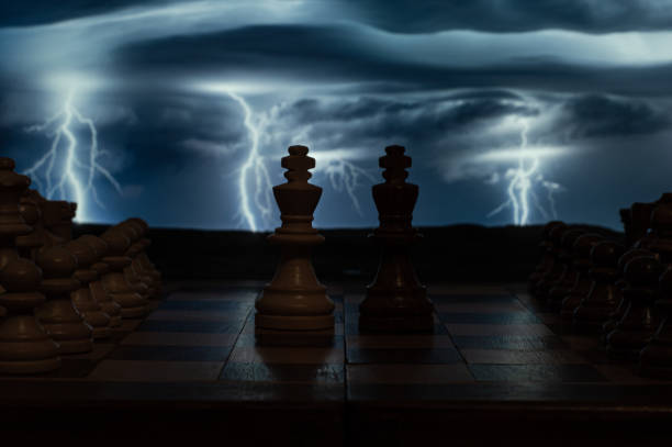 istock Game-in-play chess board with a thunderstorm background with lightning and lightning on a cloudy day that adds intensity and tension. 1297646979