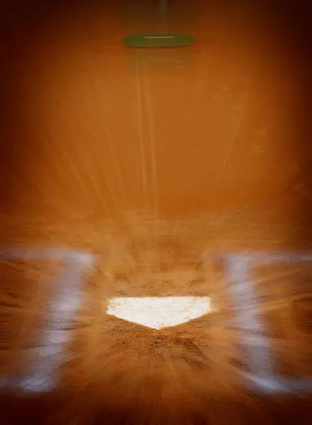 Baseball homeplate with batter box chalk lines in brown clay dirt zoom action