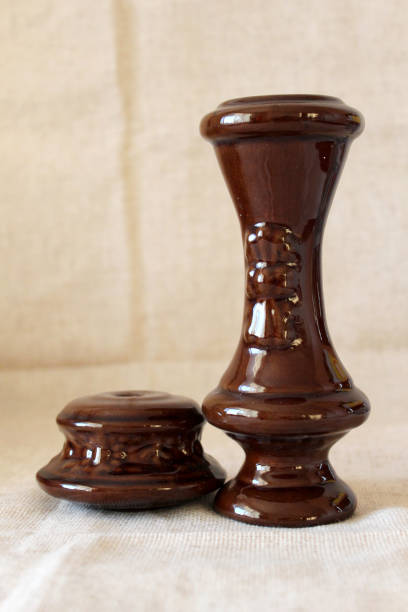 istock Old brown lacquered vases on linen background close up 1297648605