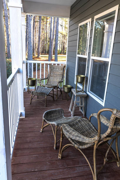 istock Small blue gray mobile home front porch with rattan chairs 1297649406