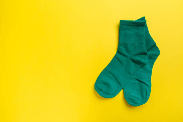 istock colored socks on a yellow background. View from above. Many different socks for cold seasons 1297649620