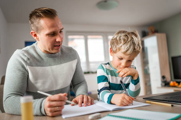 istock Father and son during homeschooling 1297649988