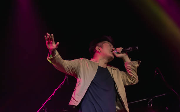 istock Asian male singer showing his performance on stage 1297650138