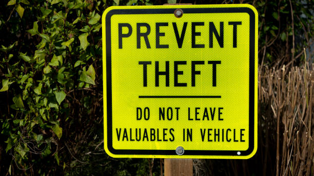Yellow metal prevent theft sign stock photo