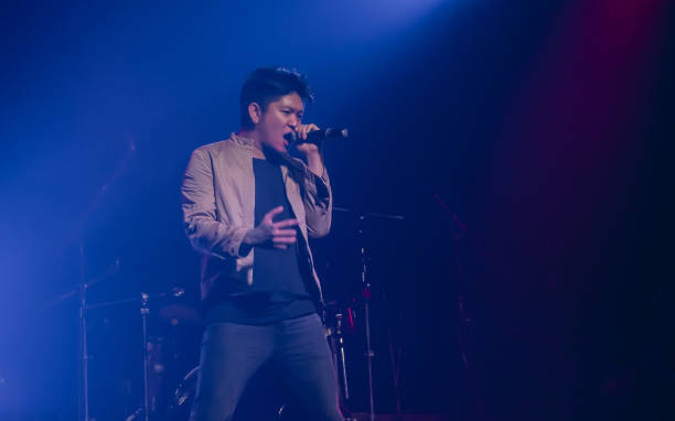 istock Asian male singer showing his performance on stage 1297650217