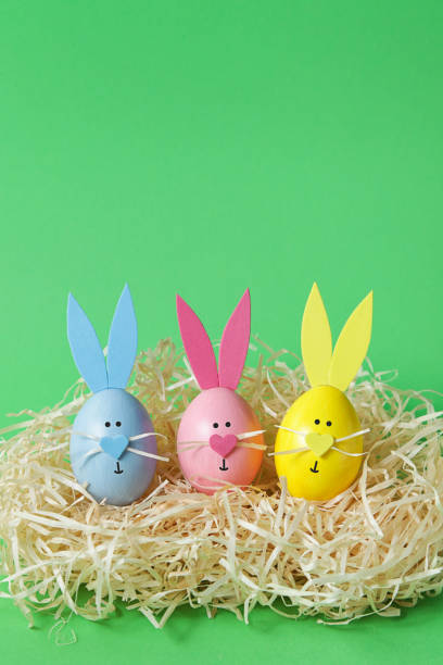 istock Easter eggs and cute bunny on green backround. Festive decoration. Happy Easter. Vertical image 1297653958