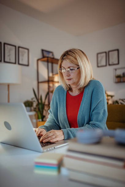 istock Responsible woman working at home on laptop 1297655001