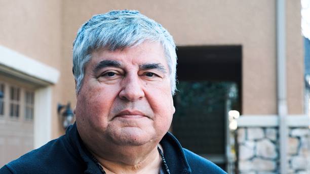 istock Smiling overweight senior mature man looking at the camera 1297657209