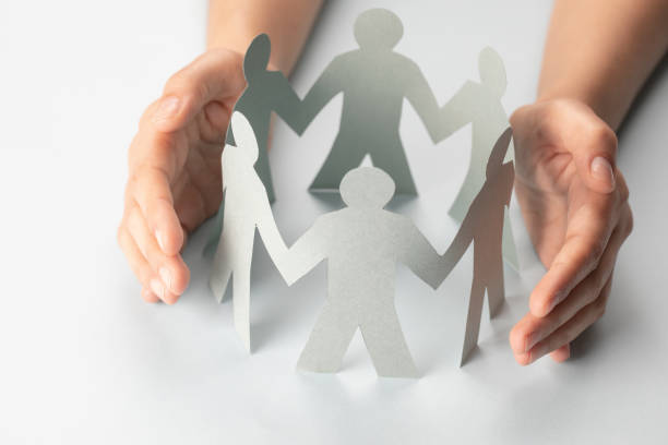 istock Hand Protecting Paper Cut Out Figure 1297658800