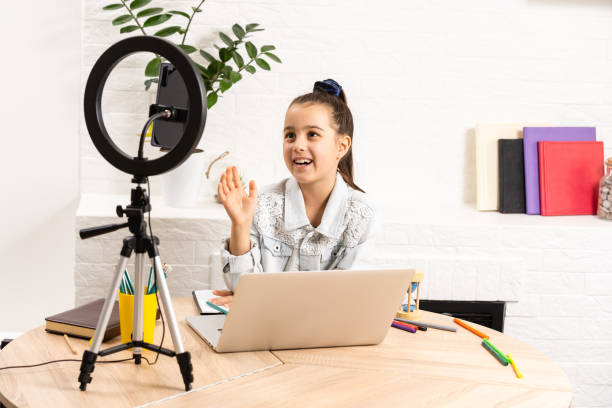 istock Video streaming. Adorable child learning new technology. Little girl using mobile phone, smartphone. Cute mobile phone technology user. Watching video on mobile device. 1297660043