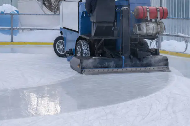 The resurfacer prepares an ice rink, closeup. An ice harvester cleans up the playground in winter. The process of preparing the winter arena for the competition.