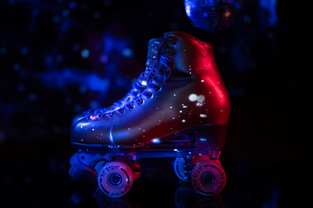 istock Golden roller skates illuminated with disco light. 1297664860