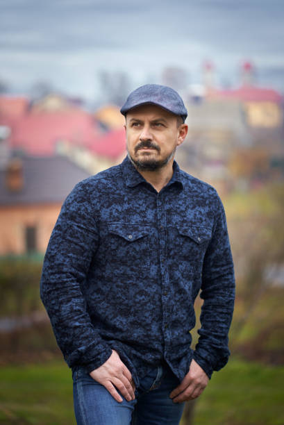 istock Farmer with village in the background 1297664940