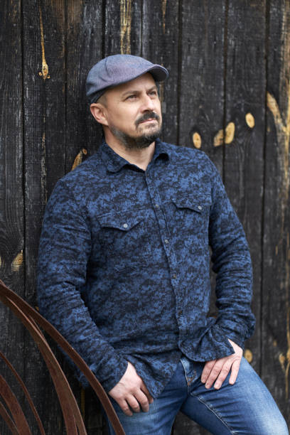 istock Man against barn wood 1297664955
