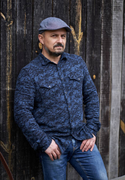 istock Man against barn wood 1297664966