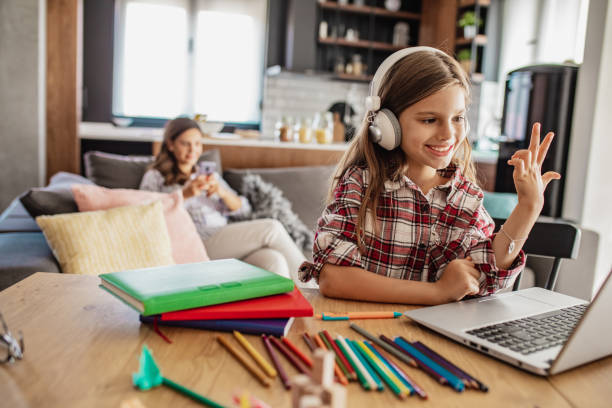 istock A little girl attends online classes at home 1297666125