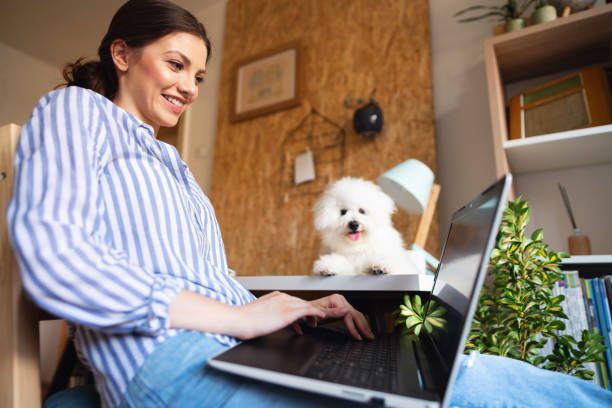 istock Smiling young woman checking her mail while her dog is laying next to her 1297669230