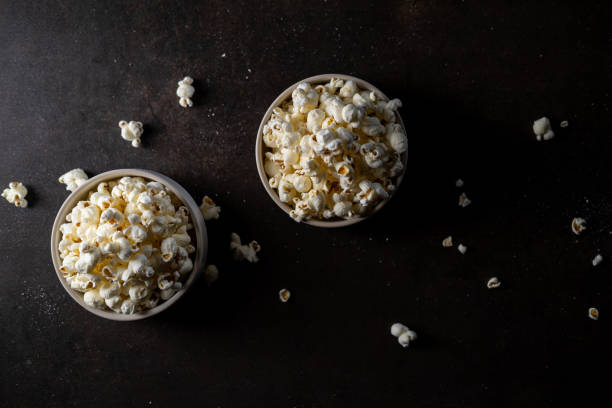 istock Two cups of popcorn on a dark background. 1297669322