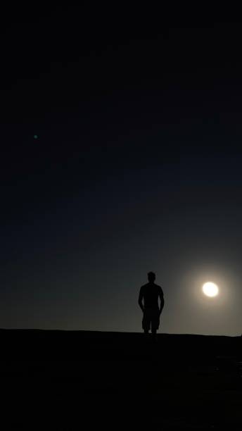 istock Man in the distance with the sun 1297670191
