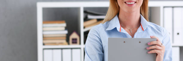 istock Business woman holding a writing tablet 1297670442