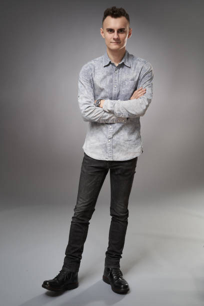 istock Young businessman on gray background 1297671100