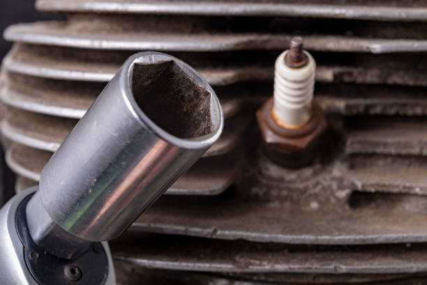 Wrench and spark plug for internal combustion engine Minor repair work on the drive unit. Workshop workplace.
