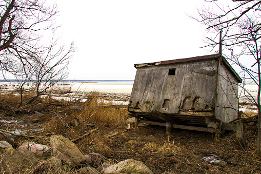 December 12, 2020 - Long Point, Ontario, Canada: An abandoned shack sits facing Lake Erie on a cold winters day.