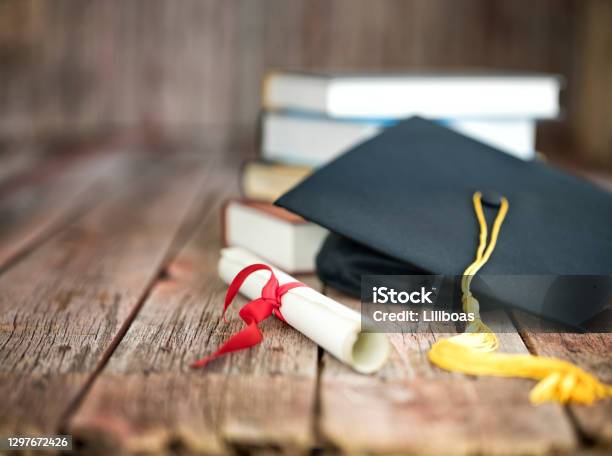 Graduation Cap And Diploma Concept On A Wood Background Stock Photo - Download Image Now
