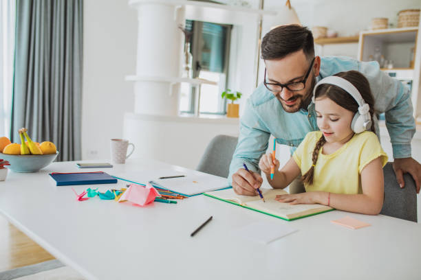 istock Father is helping his daughter do finish homework 1297674420