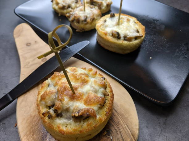 a platter of cheesy mushroom croustades or cheesy mushroom discs - vol au vent imagens e fotografias de stock