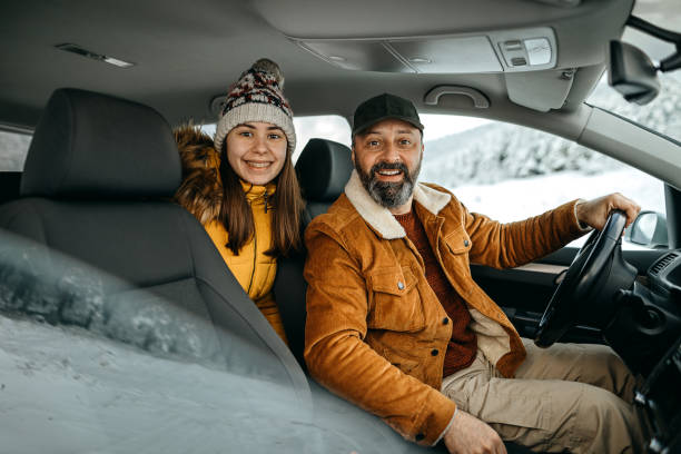 istock Father and daughter on a winter road trip 1297680152