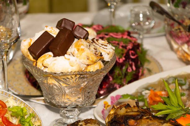 Holiday concept. A rich meal with sweets and various dishes in the background.