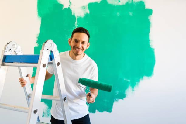 istock Smiling man getting ready to start painting his walls 1297682348