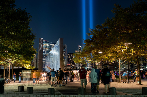 New York, New York - September 11, 2020: A view of the memorial lights rising above the lower Manhattan Island cityscape.