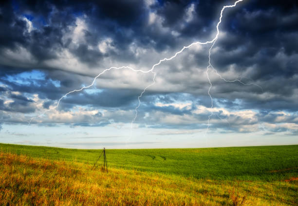 istock lightning over the meadow. stormy sky over rural landscape 1297685120