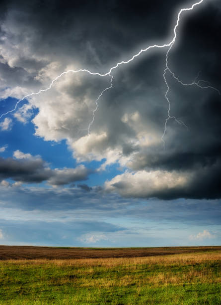 istock lightning over the meadow. stormy sky over rural landscape 1297685148