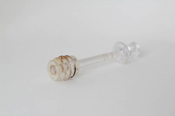istock white plastic spoons for the honey on white background 1297685468
