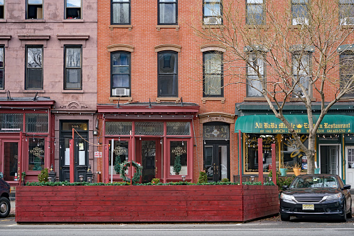 Hoboken, NJ, USA - December 28, 2020:  Hoboken's main street has local shops in well preserved 19th century buildings.