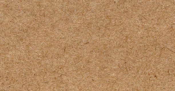 istock Kraft packaging paper texture, macro shot. Sharp and detailed surface. Blank brown paper. 1297686226